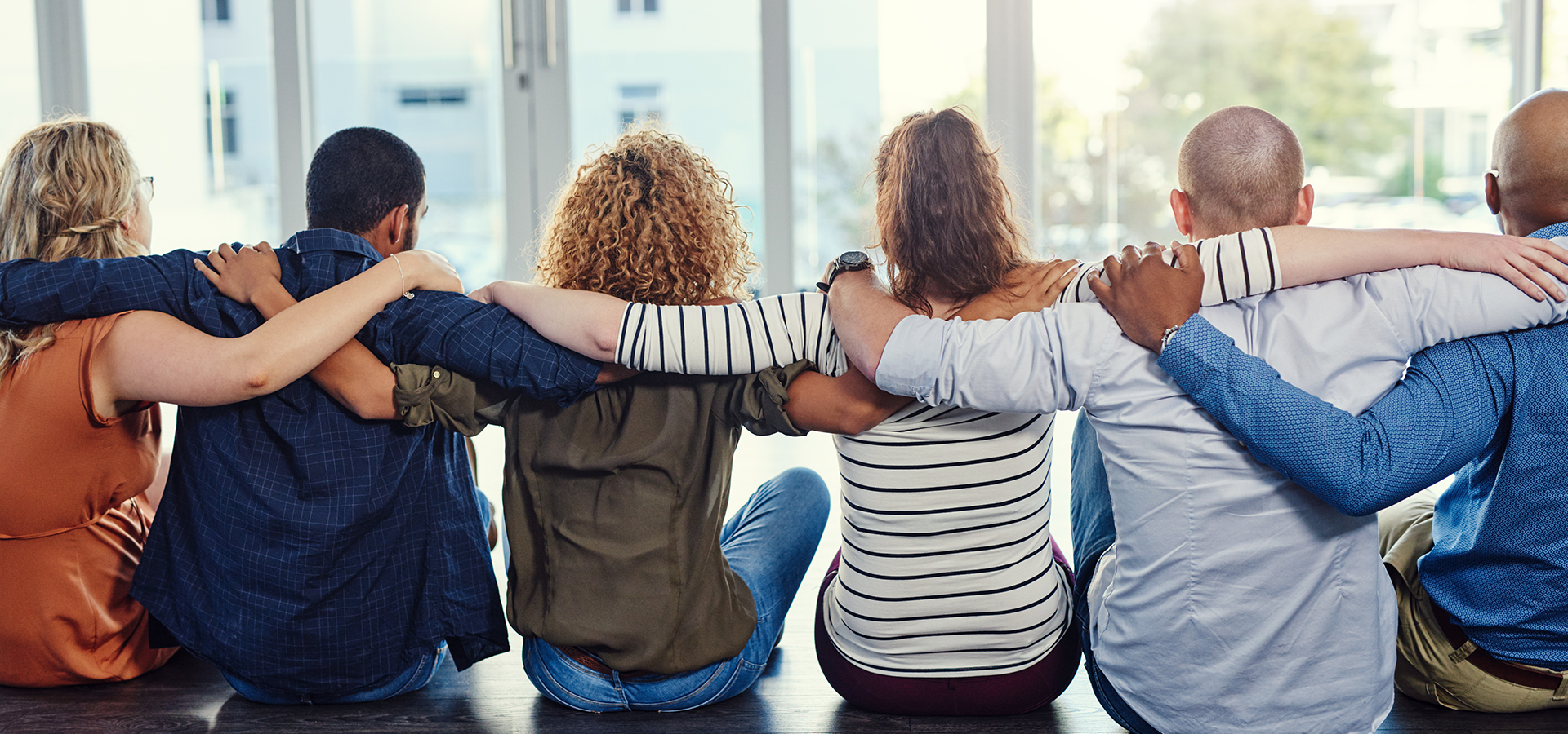 Friends hugging and looking into the future